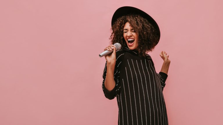 successful musician women singing into microphone